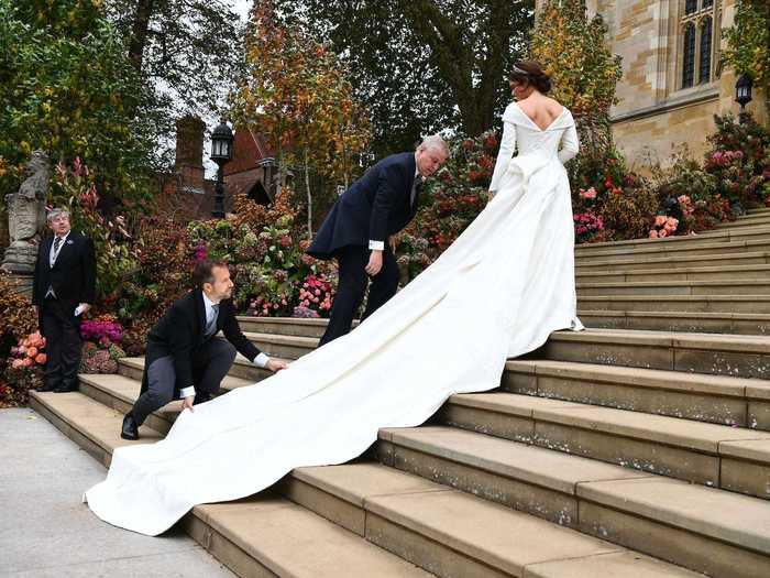 Princess Eugenie opted for a wedding dress by Peter Pilotto and Christopher De Vos. This photo of the princess on the chapel step shows off the gown's neckline and flowing train from an angle that isn't as visible in the other wedding pictures.