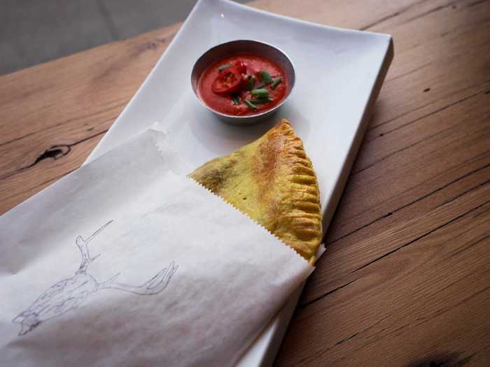 According to Culture Trip, a Jamaican patty is a golden semi-circle pastry filled with meat, spices, vegetables, and sometimes even fruit. It's similar to a baked empanada.