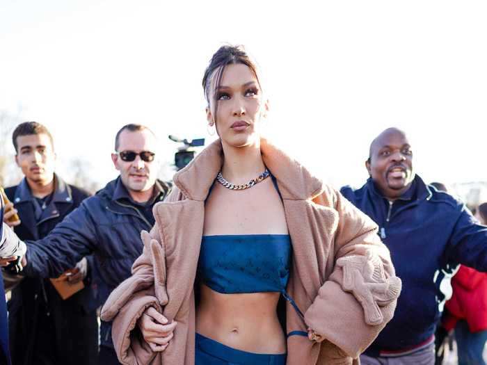 Bella Hadid started the year strong with a blue crop top, matching blue low-rise pants, and a tan oversized coat.