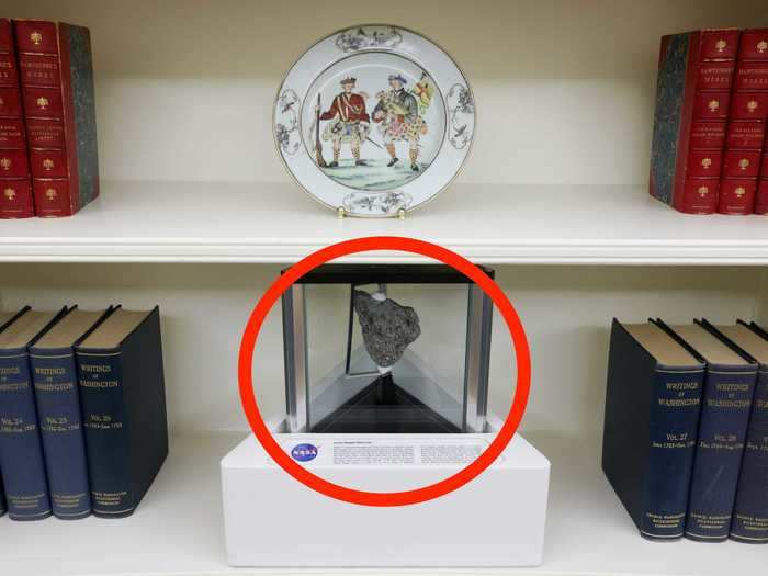 A moon rock sitting on a bookshelf and a portrait of Benjamin Franklin put his love of science on prominent display.