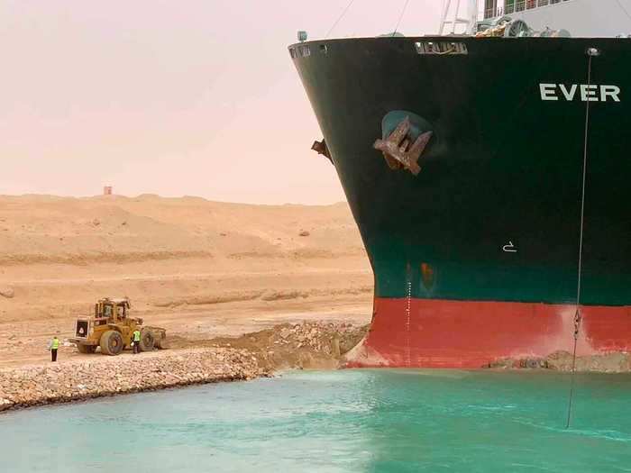 Let's begin with an up-close look at the Ever Given. In this photo released by the Suez Canal Authority, crews are working on shore to refloat the ship.