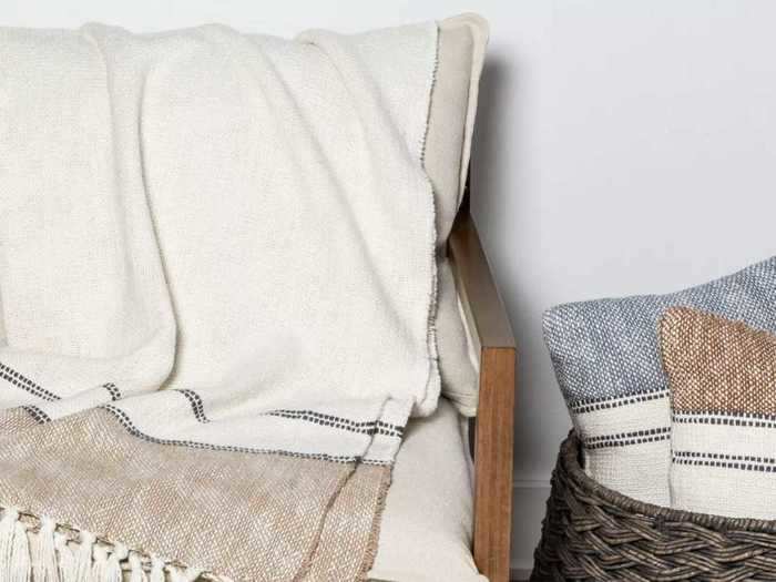 Upgrade your space with this border-striped cotton throw blanket.
