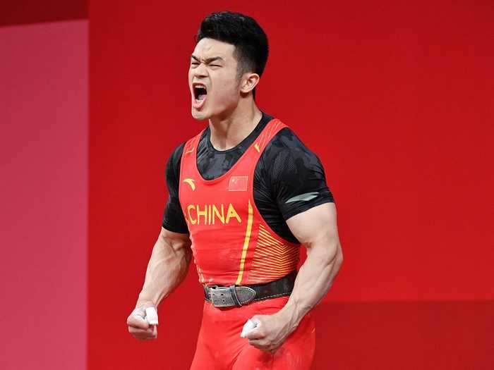 Shi Zhiyong celebrated after winning the gold in men's 73-kilogram weightlifting for Team China on July 28.