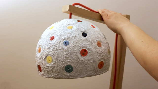 artist uses recycled paper to create papier mch lampshades.