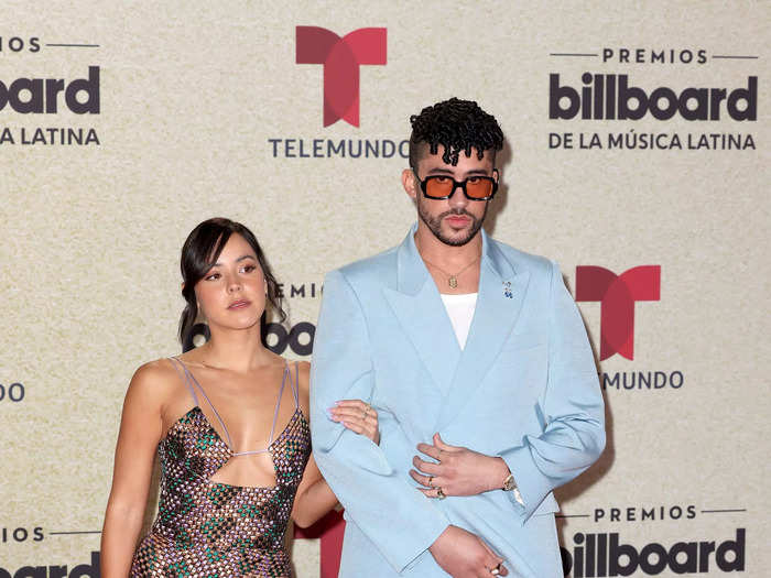 While Bad Bunny wore a pastel-blue suit, his girlfriend, Gabriela Berlingeri, wore a geometric-print dress with a thigh-high slit and plunging neckline.