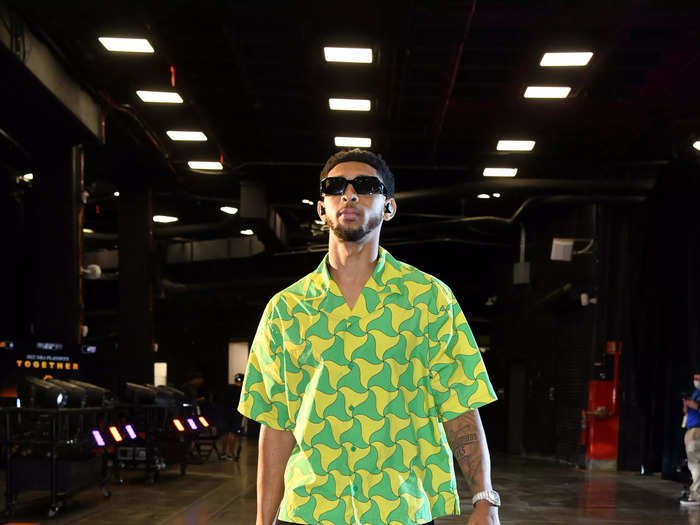 Phoenix Suns star Cam Payne made a statement with a patterned green and yellow shirt with dark sunglasses.