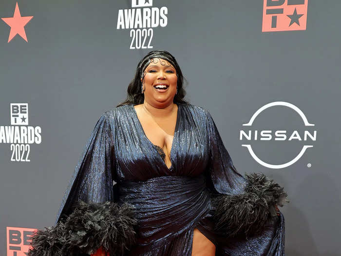 Lizzo brought high drama to the BET Awards red carpet in a ruched navy gown with black feathers.