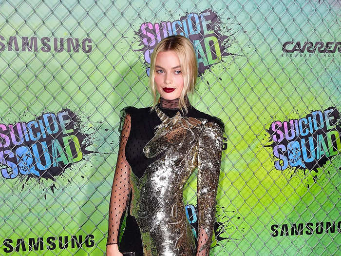 At the "Suicide Squad" premiere in 2016, Margot Robbie wore a black maxi gown with long sleeves and a gold unicorn on it.
