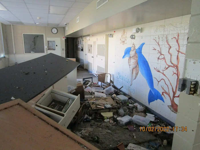 Desks and other broken furniture are piled in the hallways of Fort Myers Beach Elementary School.