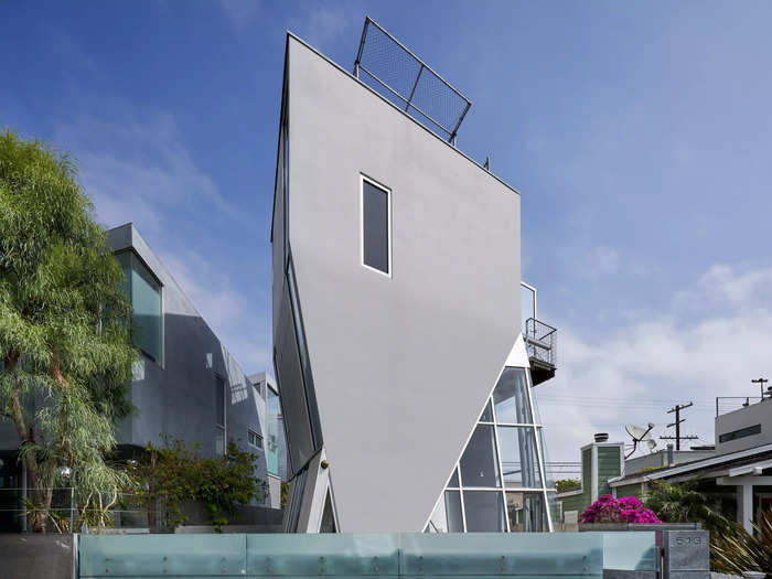 From a distance, J. Stewart Burns' house in Venice, California, looks like it's upside down. A flat roof rises up from a triangular-looking base. One wall is a nearly unbroken slab of gray, and one side of the home appears to be supported by an all-glass room.